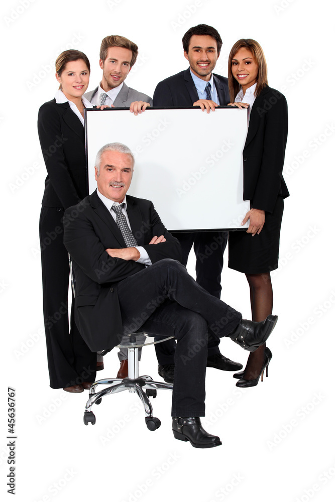 Four executives holding a board behind their boss Four executives holding a board behind their boss