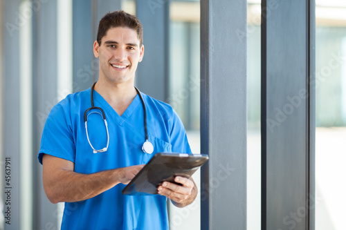 happy male healthcare worker with tablet computer
