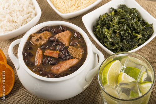 Feijoada - Brazilian meat & bean stew, side dishes & caipirinha photo