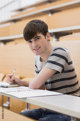Man sitting at the lecture hall smiling