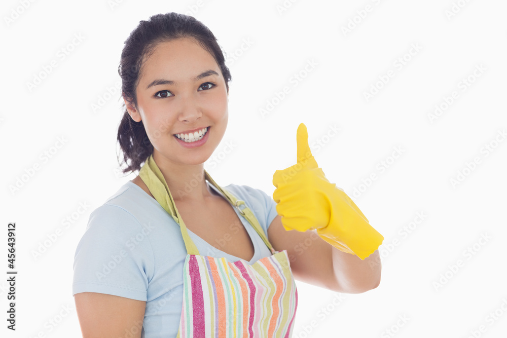 Woman giving thumbs up in yellow rubber gloves Woman giving thumbs up in yellow rubber gloves