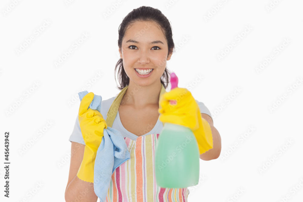Cheerful woman holding up spray bottle Cheerful woman holding up spray bottle