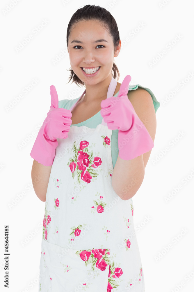 Woman wearing rubber gloves giving thumbs up Woman wearing rubber gloves giving thumbs up