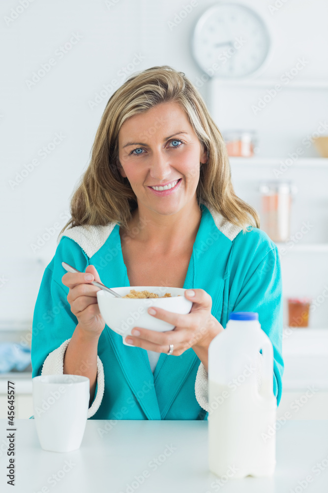 Woman having breakfast in the kitchen Woman having breakfast in the kitchen