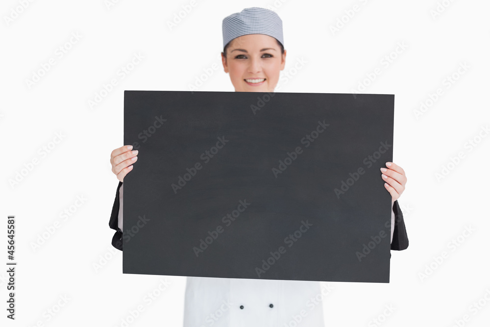 Cook holding and showing a blackboard Cook holding and showing a blackboard