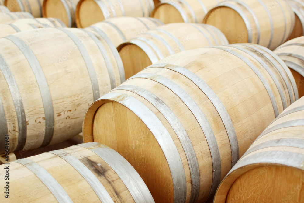 Barrels of wine stacked together.