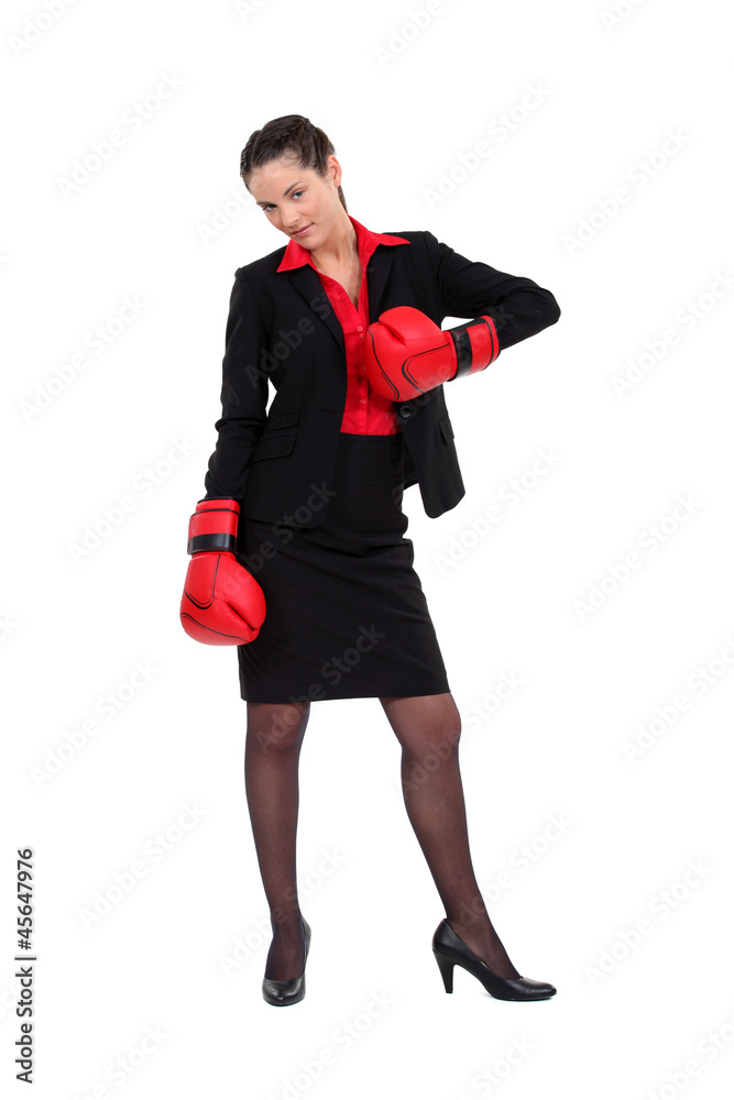 Attractive businesswoman with her punching gloves Attractive businesswoman with her punching gloves