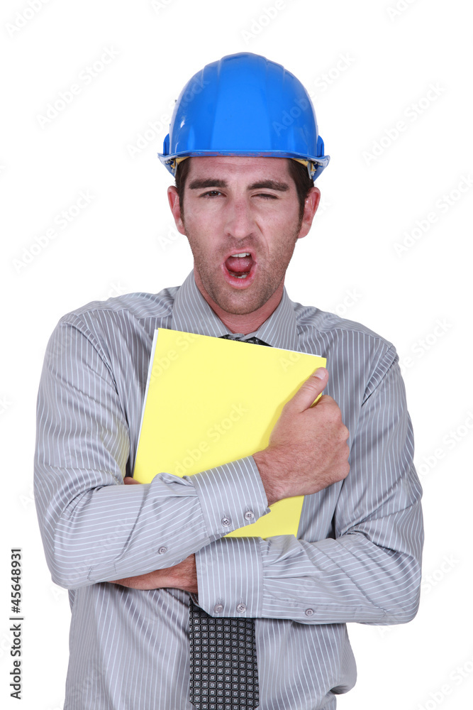 Man yawning whilst clutching paperwork Man yawning whilst clutching paperwork