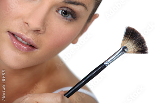 Brunette holding make-up brush