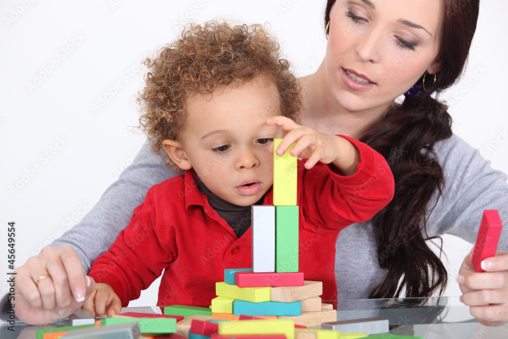 Woman and child playing with building blocks Woman and child playing with building blocks