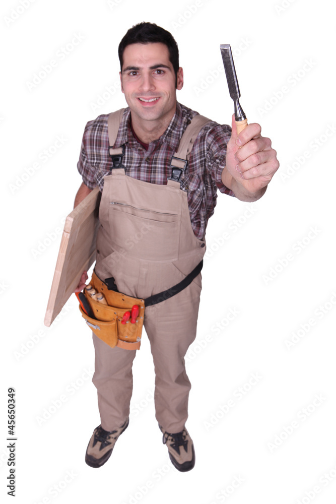 A carpenter with a chisel. A carpenter with a chisel.