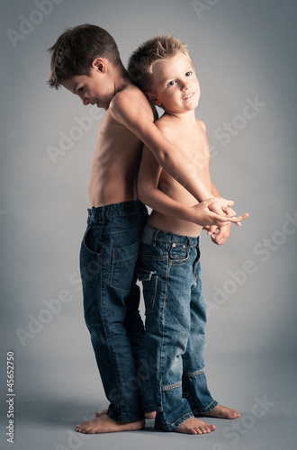 Two young brothers studio portrait.