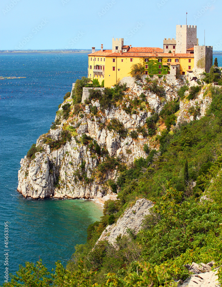 Gothic Duino castle on a cliff over the Adriatic sea, Italy. 