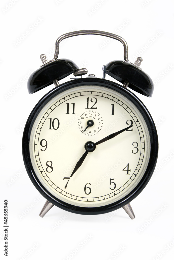 A classic old black alarm clock on white background A classic old black alarm clock on white background