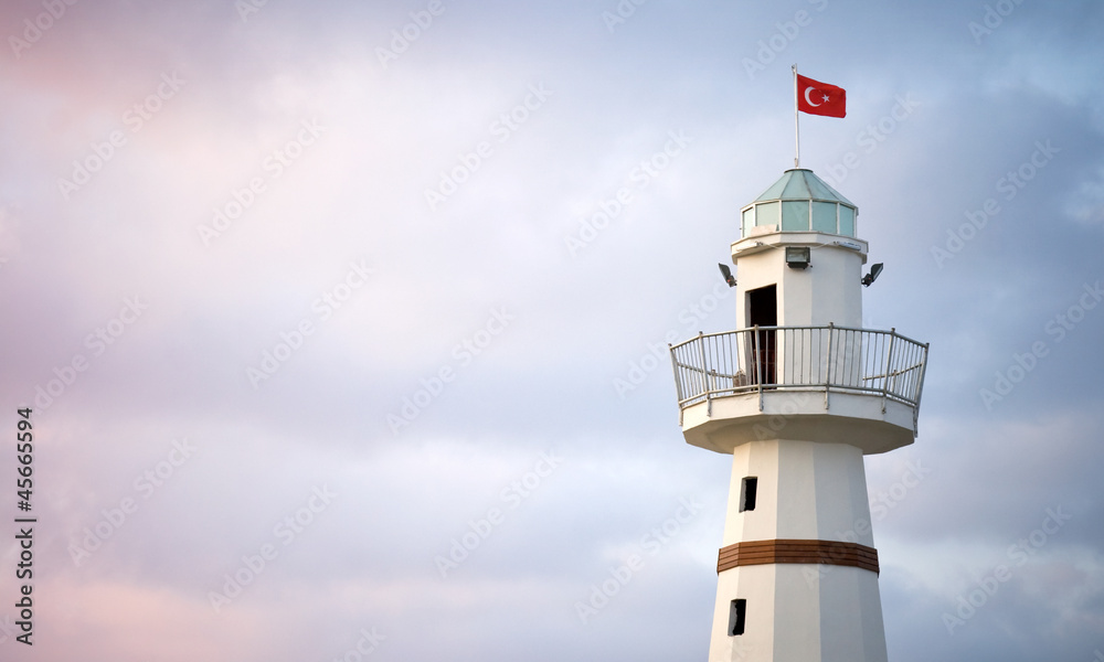 Upper part of white Lighthouse with Turkish flag