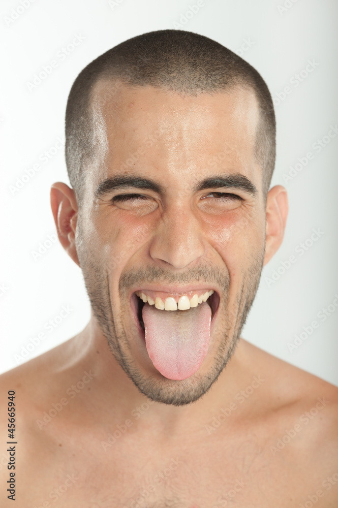 Young man sticking his tongue out Young man sticking his tongue out