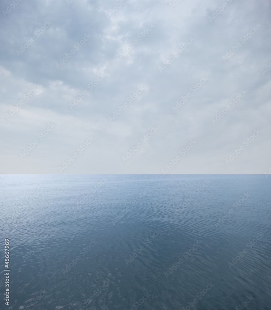 calm sea with cloudy sky at the horizon