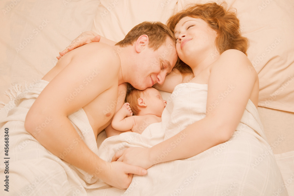 family sleeping together, Mother, father and newborn Stock Photo