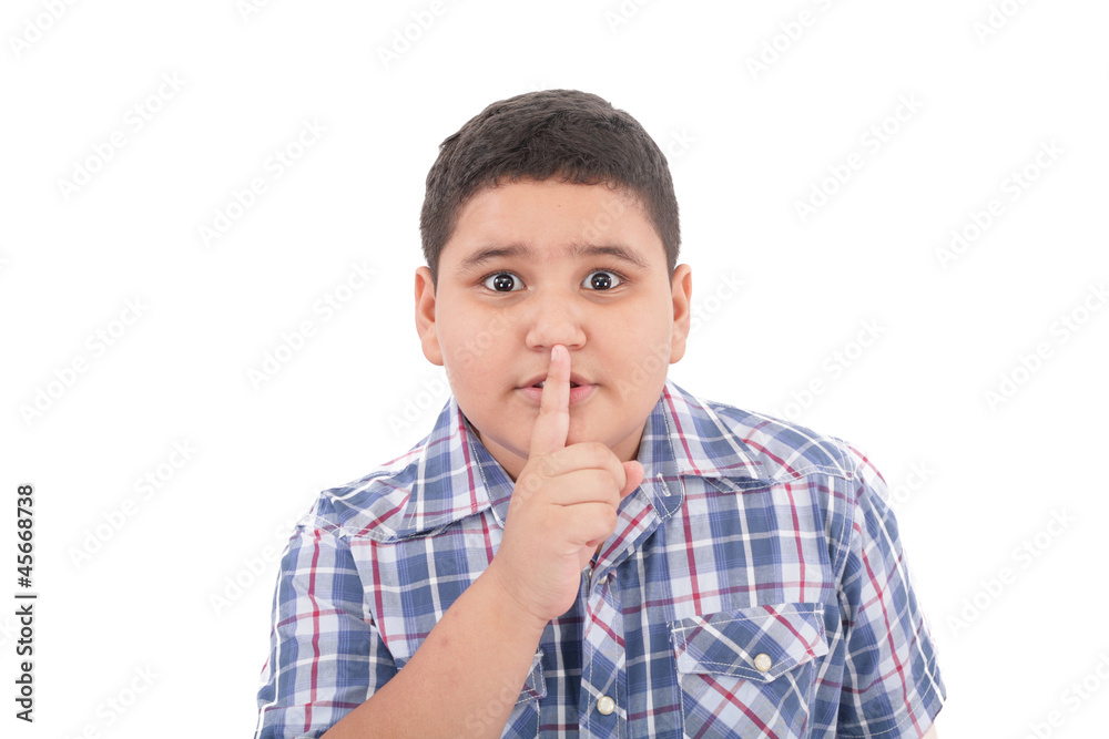 Portrait of beautiful little boy with silence gesture over white Portrait of beautiful little boy with silence gesture over white