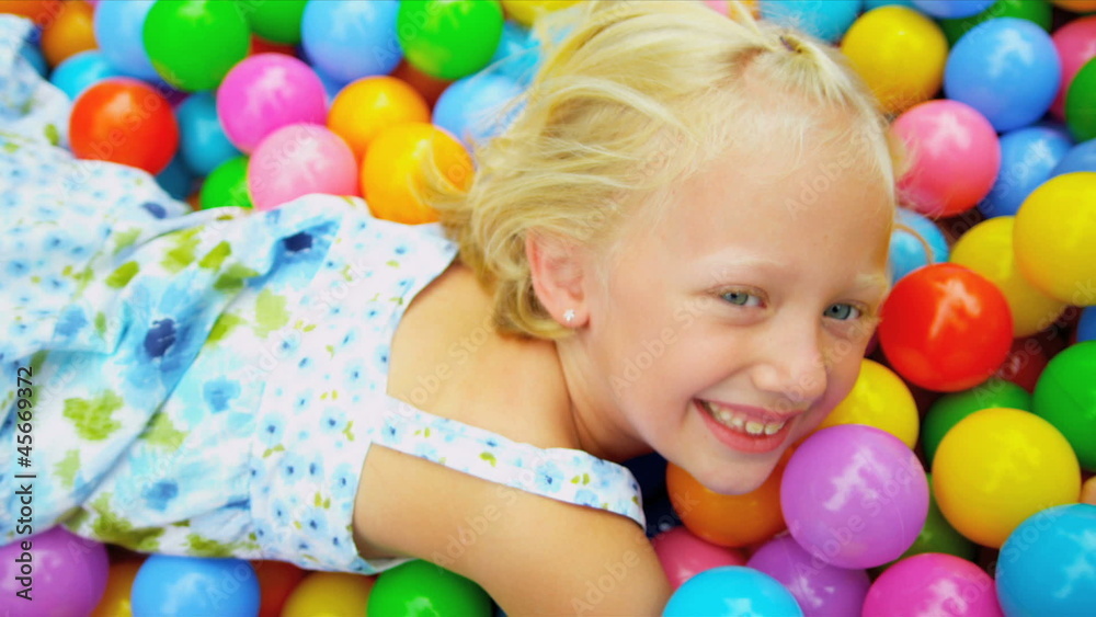 Cute Blonde Girl Enjoying Ball Pool Cute Blonde Girl Enjoying Ball Pool