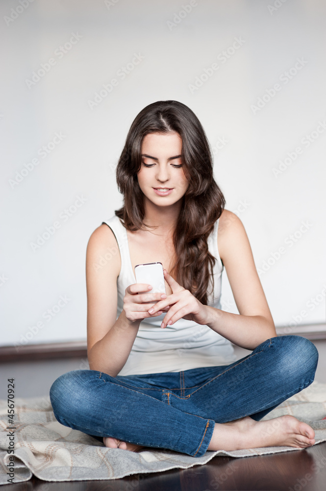 young casual happy smiling brunette girl with cell phone young casual happy smiling brunette girl with cell phone