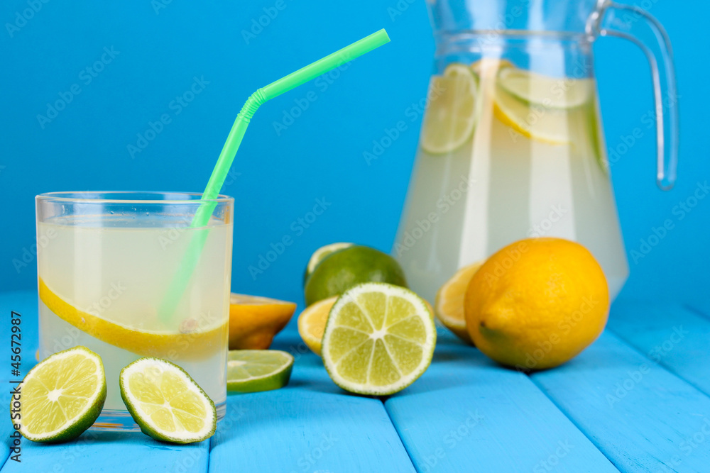 Citrus lemonade in pitcher and glass of citrus around Citrus lemonade in pitcher and glass of citrus around