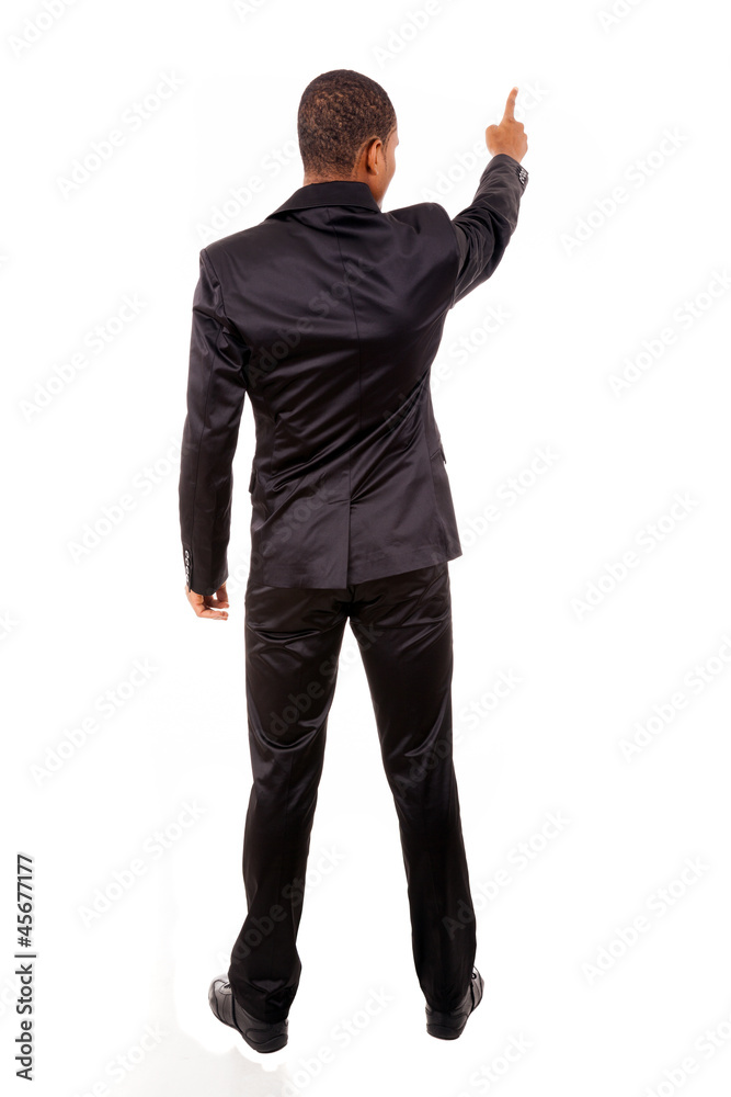 Full length of a African business man pointing at copyspace isol Full length of a African business man pointing at copyspace isol