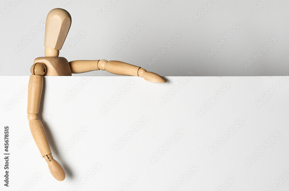 wooden man holding empty white blank banner for your text wooden man holding empty white blank banner for your text