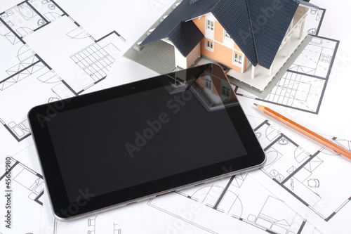 Blueprints, house and tablet