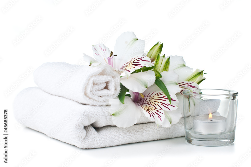 resources for spa, white towel, candle and flower
