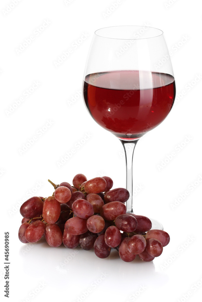 glass of wine and ripe grapes isolated on white