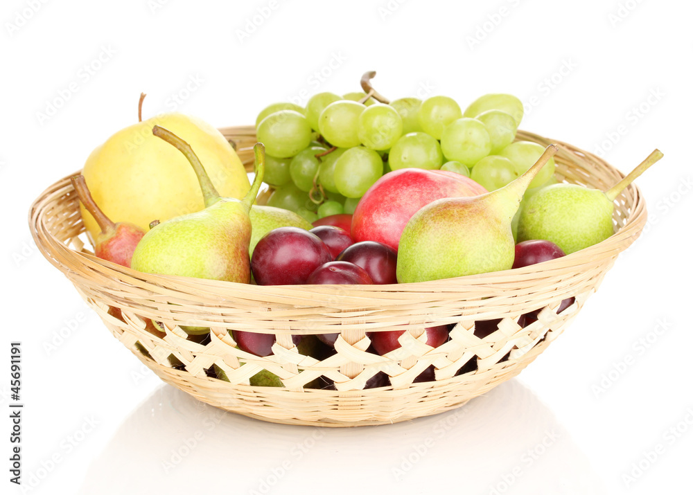 Mix of ripe sweet fruits and berries in basket isolated on
