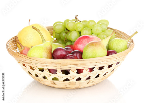 Mix of ripe sweet fruits and berries in basket isolated on