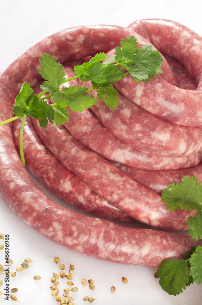 a natural raw sausage on white