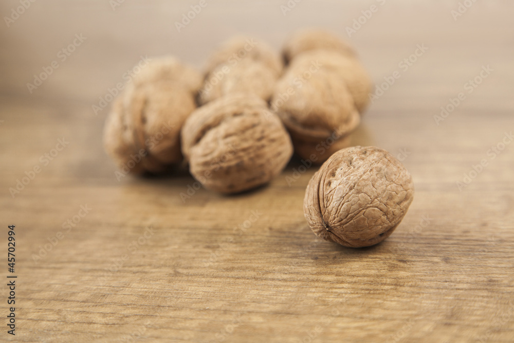 Walnuts on brown wood Walnuts on brown wood