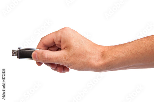Closeup image: hand holding black USB data storage or connecting