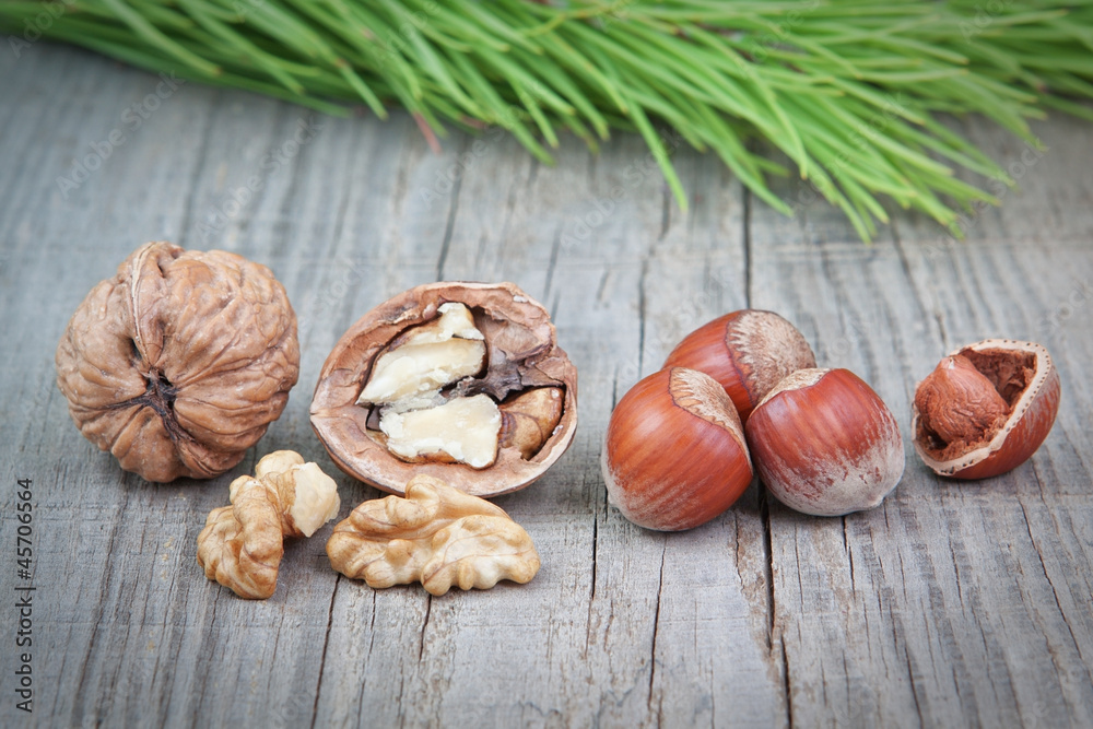 Nuts on the board on a textured background Christmas tree. Nuts on the board on a textured background Christmas tree.