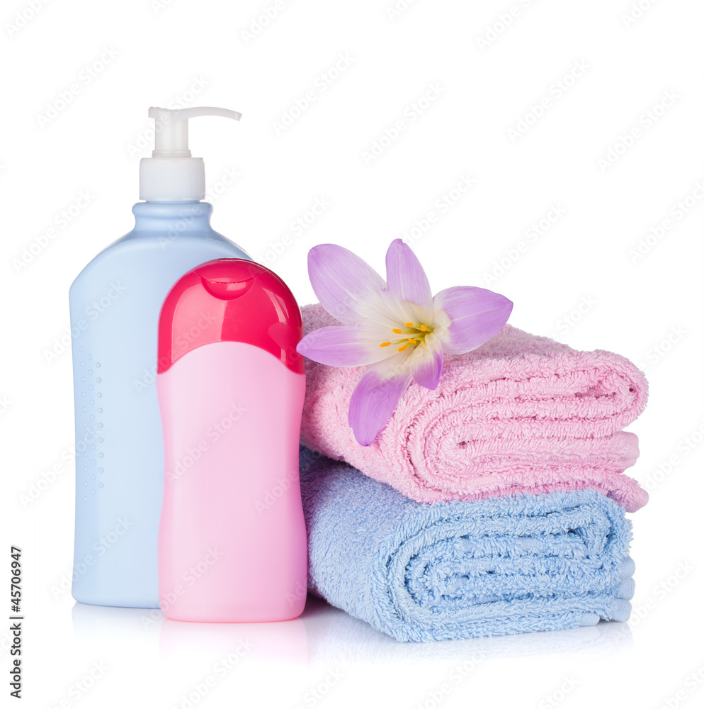 Shampoo and gel bottles with towels and flower Shampoo and gel bottles with towels and flower