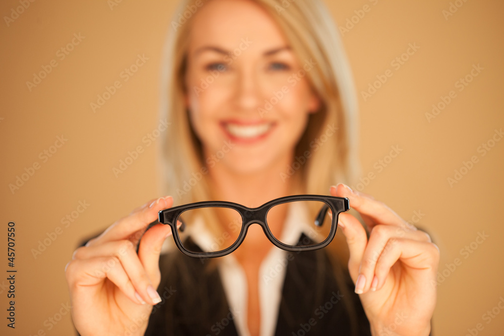 Woman holding out her spectacles Woman holding out her spectacles