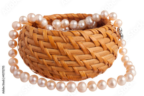 Pink pearl nacklace in a basket photo