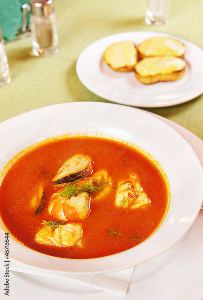 Bouillabaisse - Tomato soup with seafoods in a plate