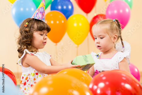 pretty children with colorful balloons and gifts on birthday par
