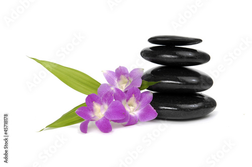 Zen pebbles balance. Three orchid and bamboo leaf