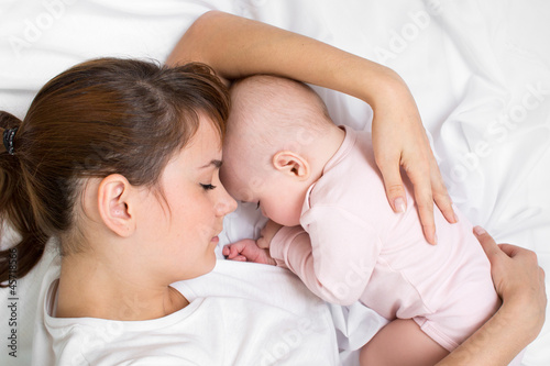 Young mother embracing her ...