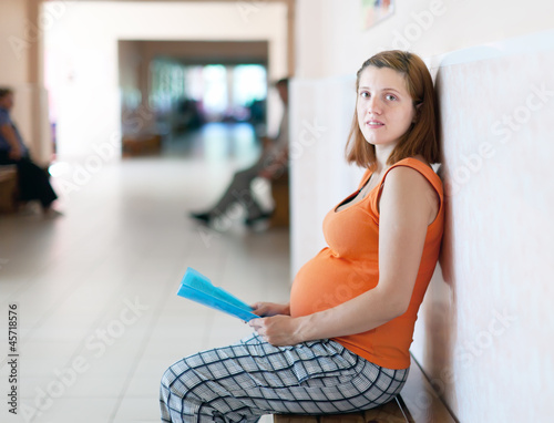 pregnant woman waits to doctor receive