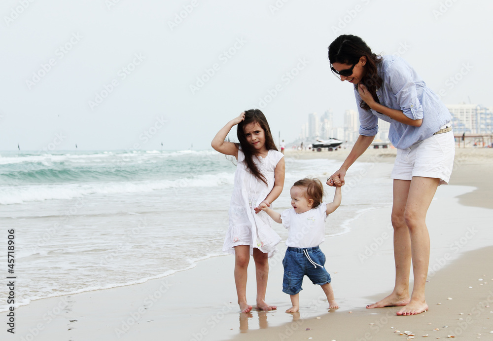 Mother with two daughters on the beach Mother with two daughters on the beach