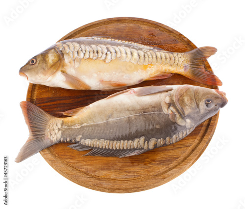fresh fish (carp) on wooden board