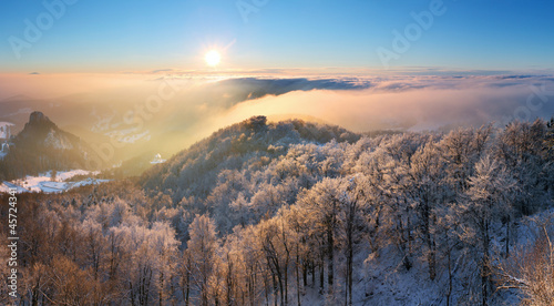 Winter sunset over the clouds