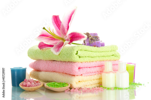 Fototapeta Naklejka Na Ścianę i Meble -  towels with lily, aroma oil,  candles, soap and sea salt