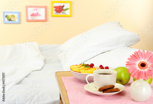 light breakfast on the nightstand next to the bed